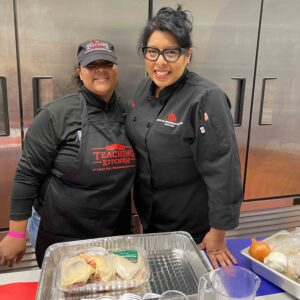 Naisha Scott, membership and aquatics director for The YMCA pauses for a smile with teaching kitchen Executive Chef Evelyn García at The Andy Murphy Neighborhood Center on Broadway in Kingston.